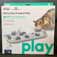 Rainy Day Puzzle & Play- Interactive Cat Treat Puzzle  * great for curious cats, stimulates natural foraging instincts  * use for feeding daily to encourage a healthy eating place  * 14 hidden treat cups designed with cats in mind  * skill level = advanced  * eco friendly material  * adjust the difficulty of the puzzle to keep challenging your cat  * specifically designed for cats with shallow treat cups  * easy to clean  * no removeable parts for safer play  * made with food safe material