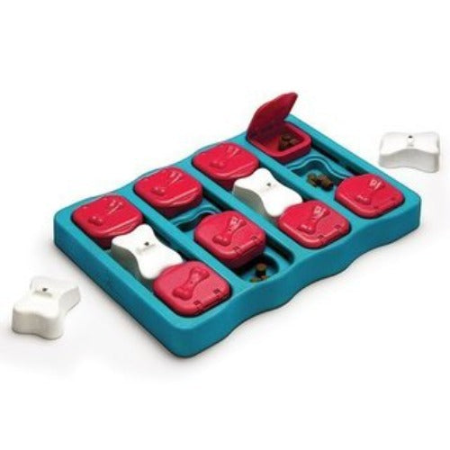 Nina Ottosson Dog Brick Blue. NEW WAYS TO LEARN & PLAY: As one of the newest, and most versatile dog games, the Dog Brick presents your pup with a new challenge every time they play with it.  FLIP, FIND & SLIDE: Complete with 3 different treat feeding features, the Nina Ottosson Dog Brick is made with easy open-close flip compartments to hide treats in, and comes with separate, removable bone puzzle pieces that offer an even more interesting challenge to seeking and eating treats! 